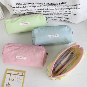 Detailed view of macaron color pencil cases with spacious interior and stationery