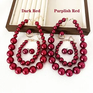 Elegant red faux pearl jewelry set including necklace, earrings and ring in dark and wine red