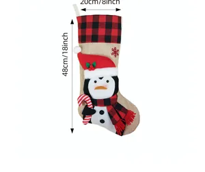Detailed view of burlap Christmas stocking featuring a penguin design with dimensions 48cm by 20cm