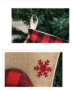 Detailed close-up of a burlap Christmas stocking with red snowflake and buffalo plaid