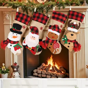 A festive set of four burlap Christmas stockings with 3D characters hanging by a warm fireplace.
