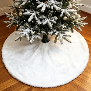 Elegant luxury white faux fur Christmas tree skirt placed on wooden floor under snowy tree