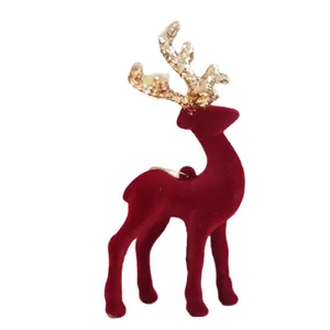 Red flocked Christmas reindeer ornament with gold glitter antlers for festive decor.