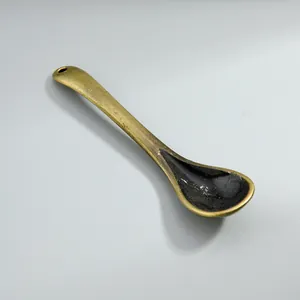 Detailed view of a vintage alloy spoon pendant for DIY jewelry making charm.