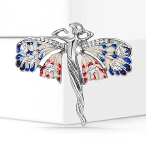 Detailed macro view of vintage angel brooch featuring enamel wings and sparkling rhinestones