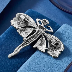 Antique silver-toned angel brooch featuring a secure pin back on blue velvet background