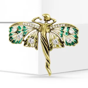 Detail view of a vintage gold-tone angel brooch with green enamel and rhinestones.