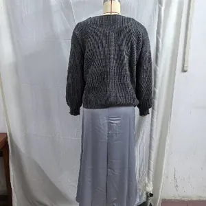 Back view of a dark grey textured knit sweater paired with a grey satin midi dress set.