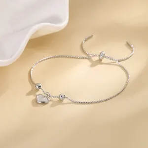 Minimalist adjustable silver chain bracelet featuring a shell heart pendant and silver beads