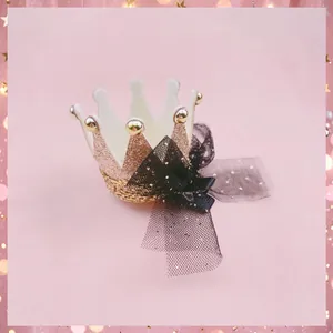 Close-up detail of a sparkling sequin crown hair clip with a delicate black mesh bow