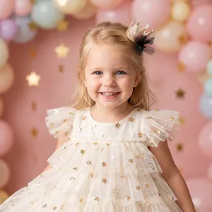 Detailed view of a glittering gold sequin crown hair clip worn by a smiling little girl