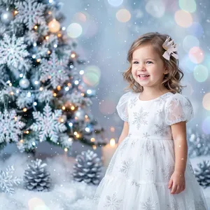 Toddler girl wearing a glittering princess crown hair clip in a festive snowy setting