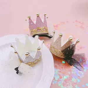 Close-up of glitter crown hair clips with mesh lace for girls' party headwear style.