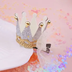 Close-up of a glittery silver crown hair clip with a delicate mesh bow for girls