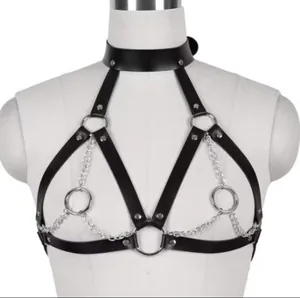 Detailed view of punk style black leather chest harness with silver metal chains and rings
