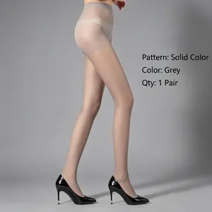 Side view of sheer grey pantyhose on model legs with black heels