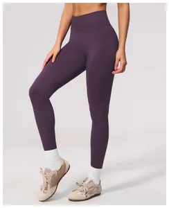 Detailed look of these deep purple seamless high-waisted yoga leggings worn by a model.
