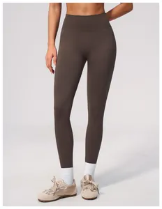 Detail of high-waisted seamless yoga leggings in brown for fitness and gym wear