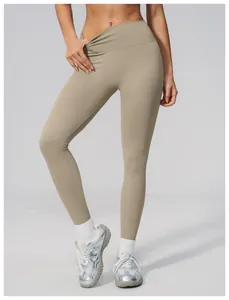 Detail view of high-waist seamless yoga leggings in beige for gym and running sessions.