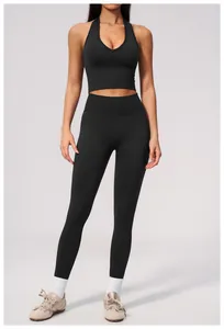 Full view of black seamless yoga set showing high waist fit and halter neck design