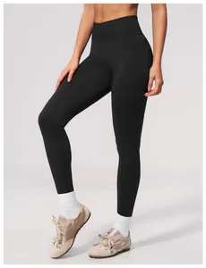Detail shot of black seamless yoga pants showing high-waisted fit and fabric texture.