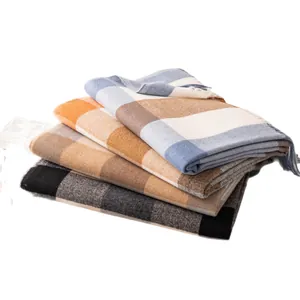 Stack of stylish checkered plaid scarves in various colors for autumn and winter warmth