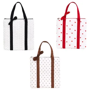 Set of three quilted tote bags featuring heart and polka dot prints with bow handles