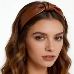 Fashionable brown PU leather wide knotted headband worn by a female model on white background