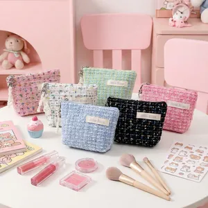 Portable mini tweed makeup pouch in multiple pastel colors with zipper closure