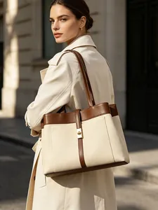 Elegant large capacity canvas tote bag with leather trim and gold-tone clasp for women.
