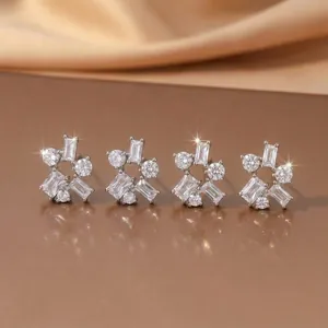 Close-up of elegant silver geometric stud earrings featuring clear zircon stones