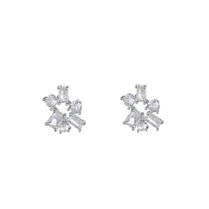 Detailed view of silver zircon stud earrings with mixed-cut geometric clear stones.