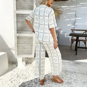 Chic bohemian two-piece vacation set featuring geometric sun print shirt and wide-leg pants