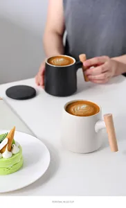 Minimalist matte ceramic mug with natural wooden handle in a lifestyle tea setting