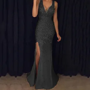Elegant dark V-neck evening gown with high leg slit and shimmering textured fabric