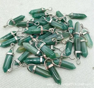 Macro detail of natural green agate hexagonal bullet-shaped pendants with silver metal caps.