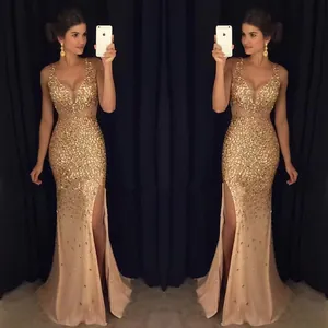 Elegant gold sequined evening gown featuring a sexy high slit and deep V-neckline