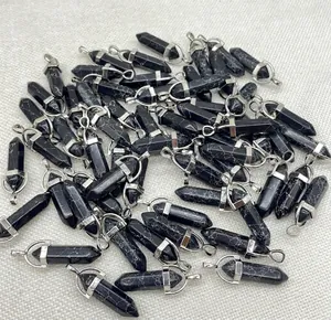 Close-up of bulk black marble hexagonal pillar bullet pendants with silver clasps.