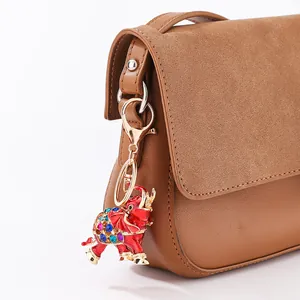 Vibrant red elephant keychain featuring multi-color rhinestones attached to a brown bag