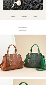 Detailed view of crocodile embossed women's handbags featuring luxury pearl charms.