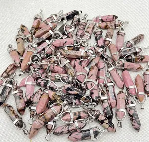 Macro view of multiple natural pink rhodonite crystal bullet pendants with silver bails