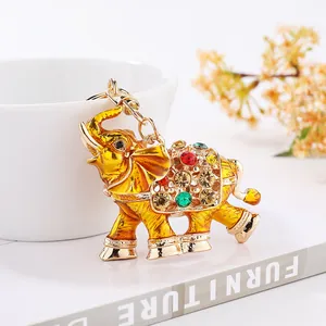 Macro detail of a golden elephant keychain encrusted with vibrant colorful rhinestones
