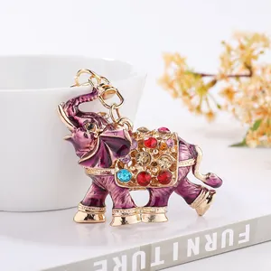 Close-up detail of ornate purple elephant keychain with sparkling multi-colored rhinestones