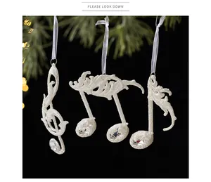 Exquisite sparkling white musical note ornaments hanging on a Christmas tree branch