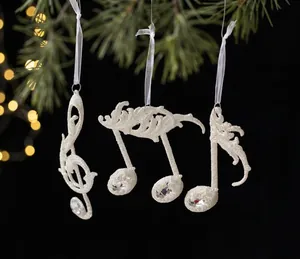 Exquis ornements de notes de musique blanc étincelant suspendus à un sapin de Noël