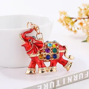 Detailed macro shot of vibrant red enamel elephant keychain with colorful rhinestones