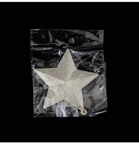 Silver glitter star Christmas tree ornament detail in clear protective plastic packaging
