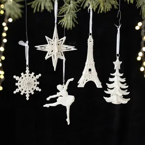 White glitter Christmas ornaments set with snowflake, star, and Eiffel tower decor