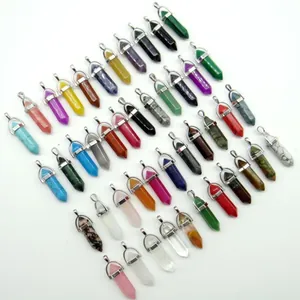 Various natural crystal and stone hexagonal bullet pendants in assorted vibrant colors