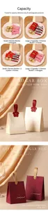 Detailed view of elegant cream and burgundy sugar boxes with floral leather handles